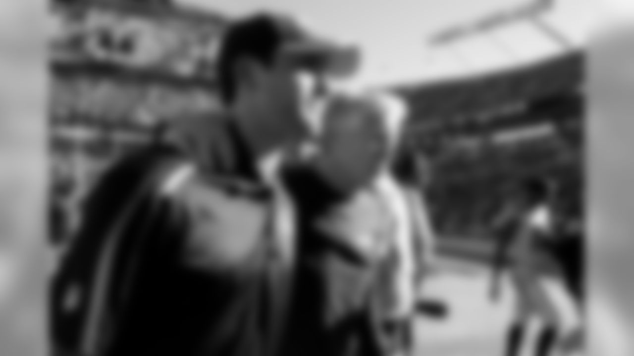 Head coach Pete Carroll walks off the field with his son Nate after the Seahawks snapped a two-game losing skid with a tough road win in Carolina, their third victory in three years against the Panthers.