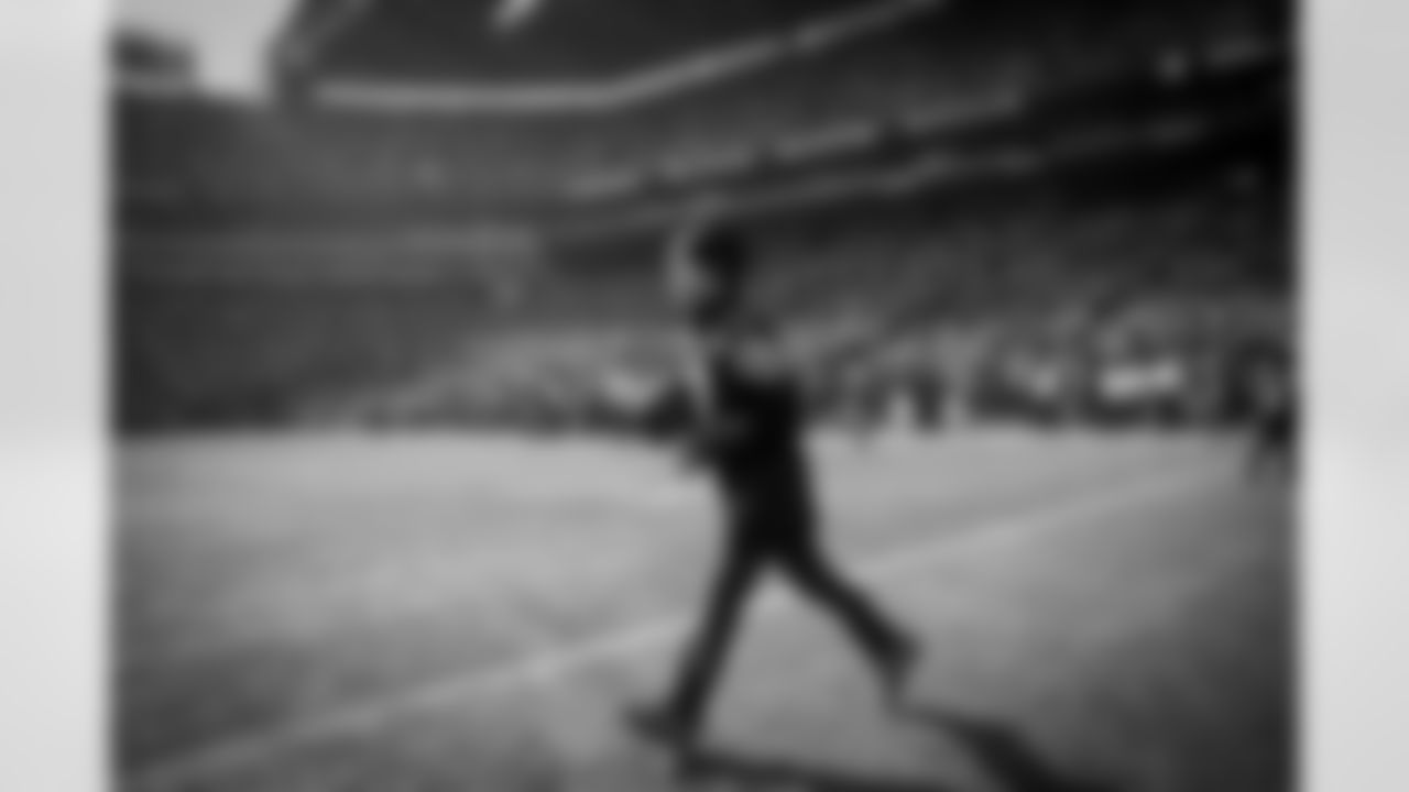 Make-a-Wish recepient Kevin Lee runs the ball onto the field for kickoff.