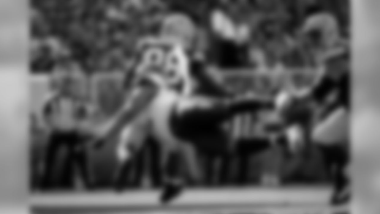 Seattle's Michael Bennett goes airborne in pursuit of Green Bay's Ty Montgomery.