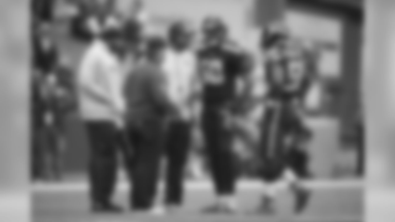 Linebackers K.J. Wright and Kevin Pierre-Louis listen to linebackers coach Michael Barrow during a timeout, along with injured linebacker Bobby Wagner and trainer Donald Rich.