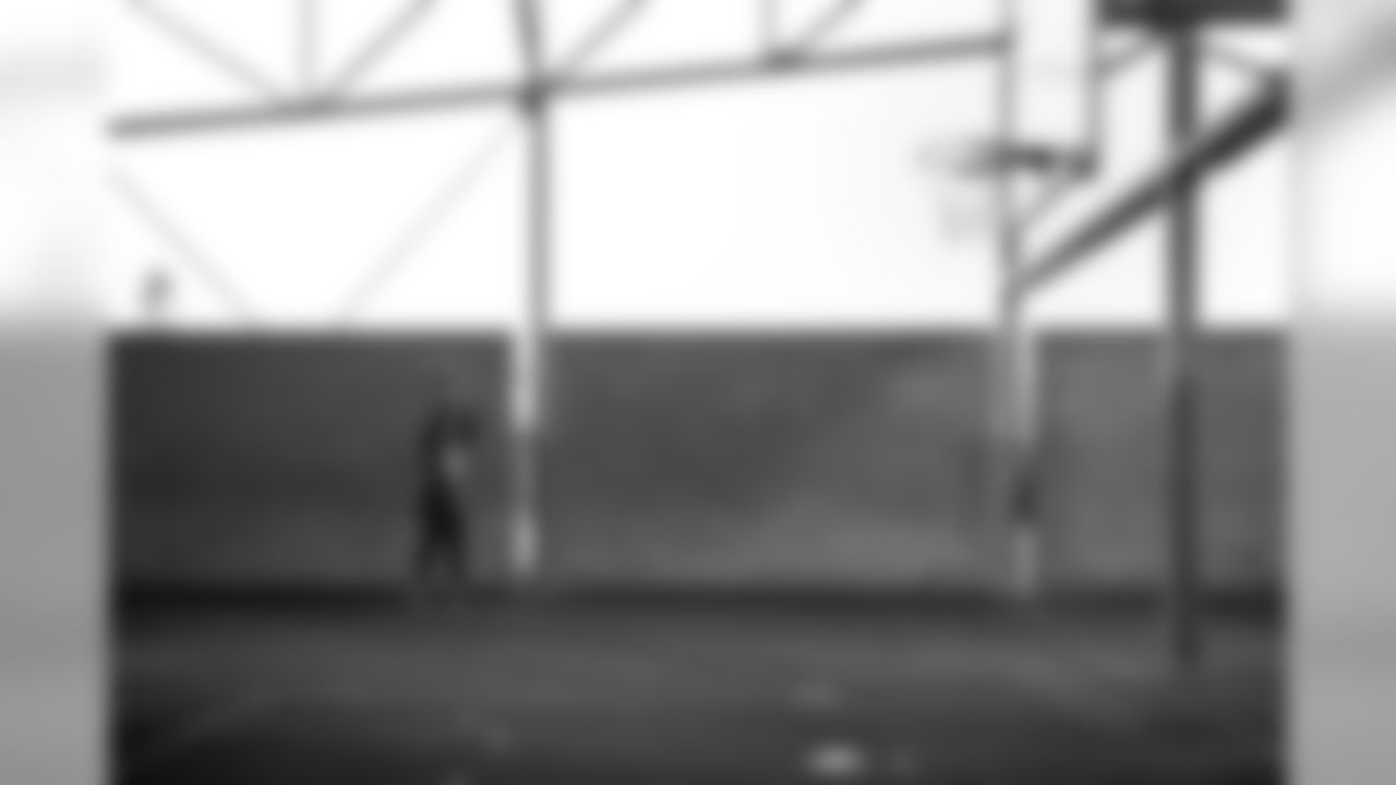 Quarterback Russell Wilson spotted a basketball hoop near the practice field and paused to fire off a few three-pointers.