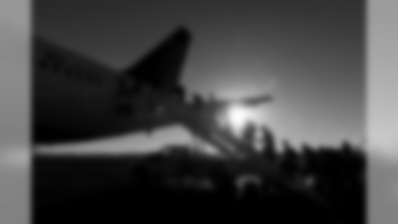 Seahawks players board their Delta charter for the long flight home as the sun sets in North Carolina. Three years straight the Seahawks have traveled to Carolina and returned home with a victory.