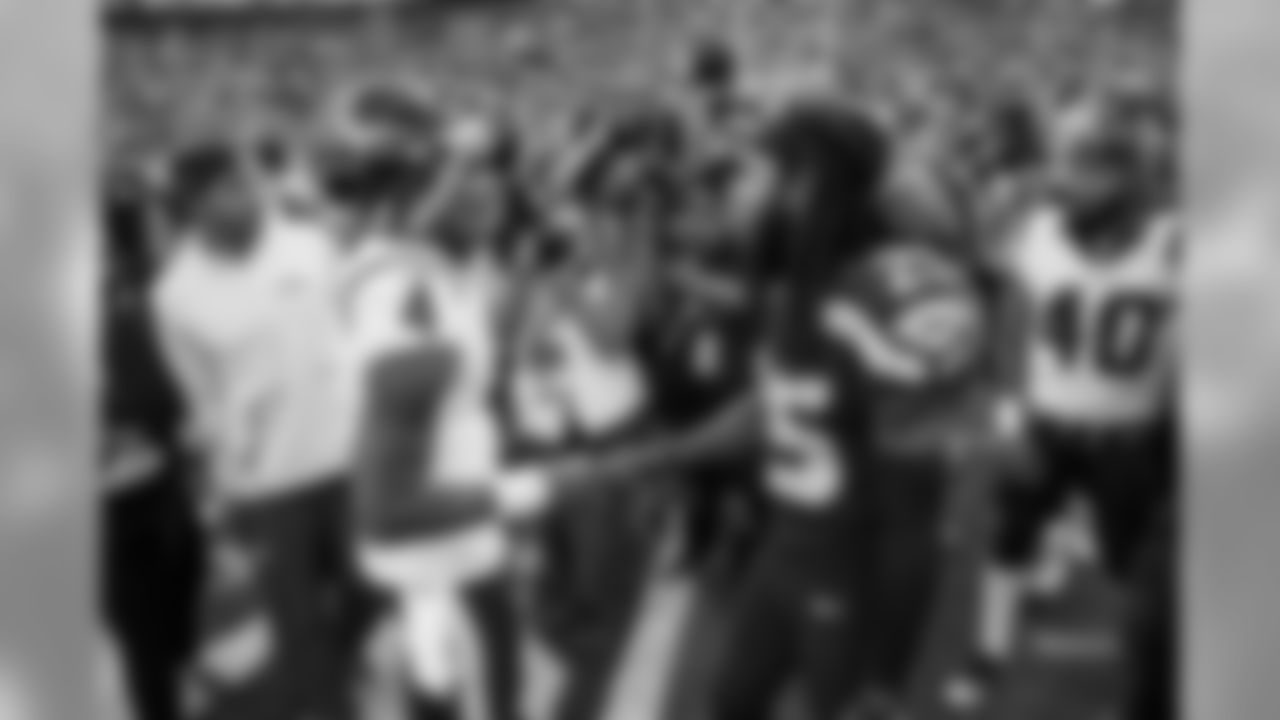 Houston quarterback Deshaun Watson and Richard Sherman meet at midfield after the game.