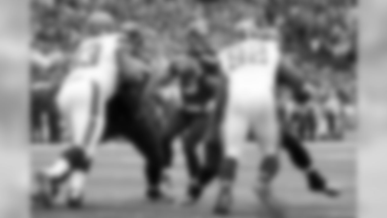 Seahawks quarterback Russell Wilson readies to throw a three-yard touchdown pass to receiver Doug Baldwin while lineman Patrick Lewis and Justin Britt provide a clean pocket.