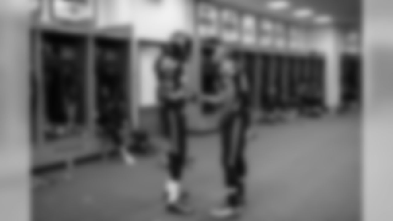 In the locker room, teammates and friends Richard Sherman and Doug Baldwin talk before hitting the field.