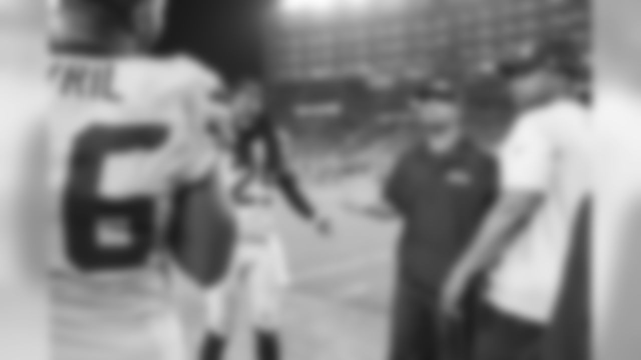 Near the end of the game, Richard Sherman, defensive coordinator Kris Richard and linebackers coach Michael Barrow enjoy a laugh with defensive lineman Cliff Avril