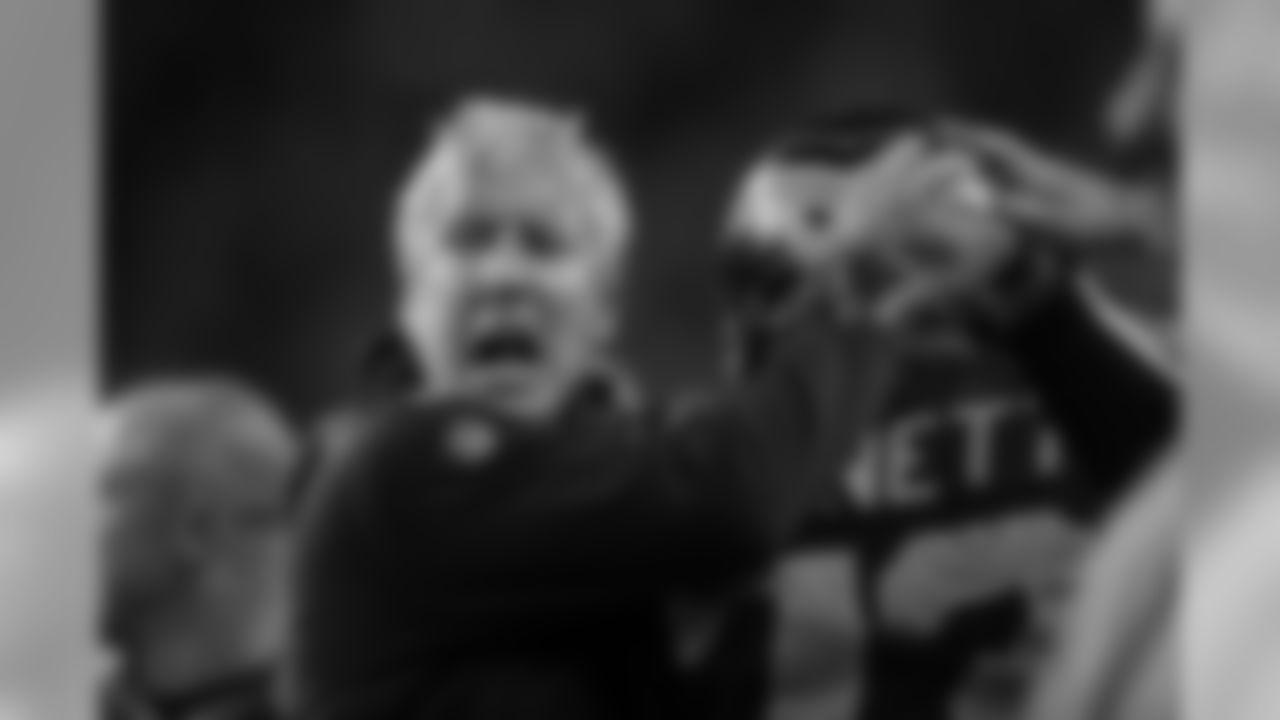 A fired-up Pete Carroll celebrates the turnover with defensive lineman Michael Bennett.