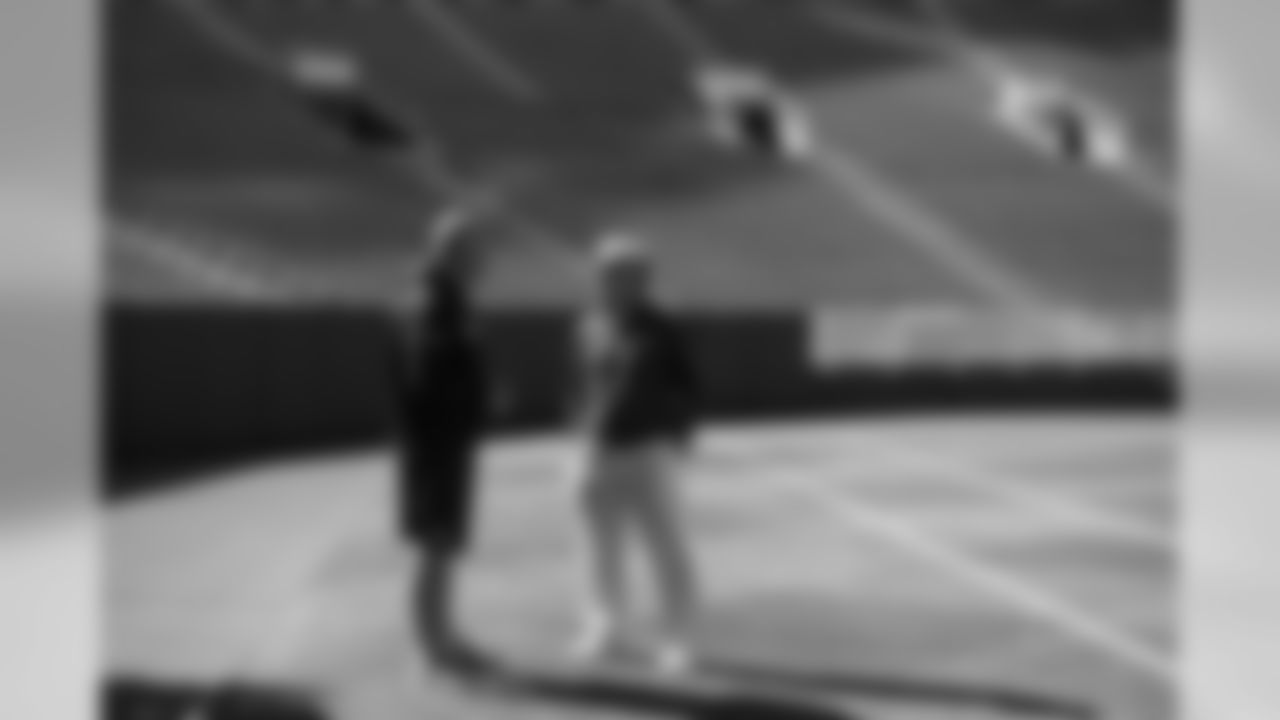 Offensive line coach Tom Cable and head coach Pete Carroll chat in an empty Lambeau Field on Saturday afternoon.