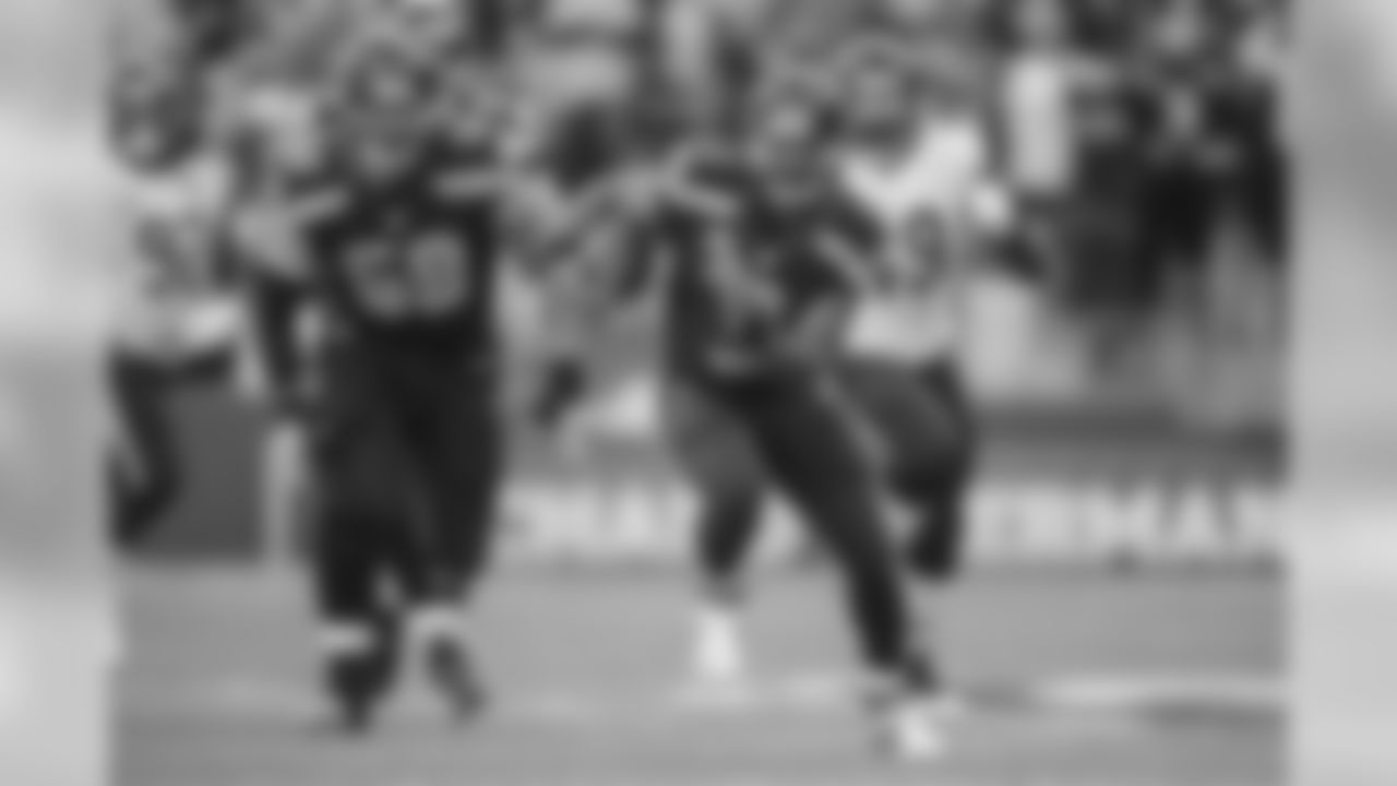 Quarterback Russell Wilson races up the middle of the field for yardage in the second half, after being sprung for the opening by linemen Justin Britt and Drew Nowak.