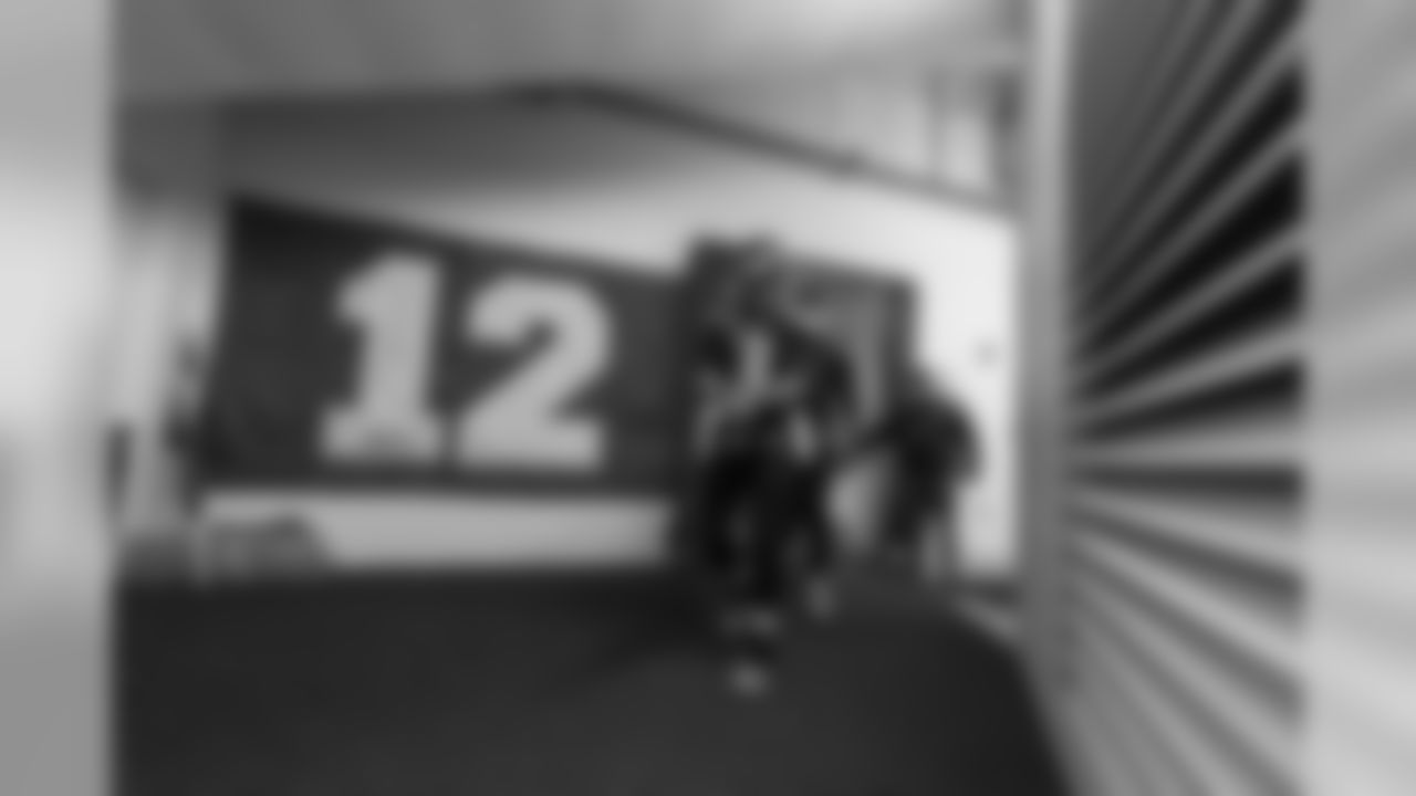 Quarterback Russell Wilson leaves the Seahawks locker room and walks by the large "12 flag" that adorns the hallway leading to the field.