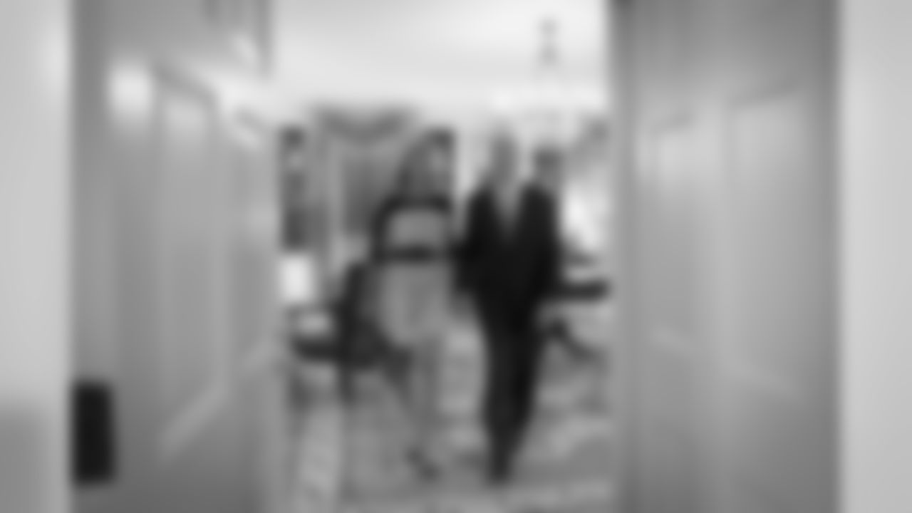 Glena and Pete Carroll hold hands as they exit the White House library. Seahawks players and coaches were able to visit many of the rooms in lower floors of the White House.