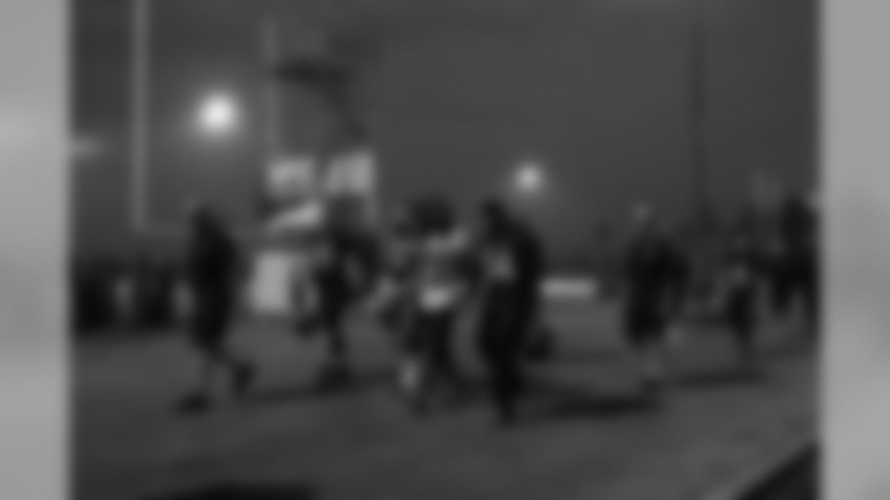 Under darkening skies, the Seahawks walk from the practice bubble to the buses that would take them back to the locker room. From left are offensive line coach Tom Cable, linemen Justin Britt and Drew Nowak, cornerback Richard Sherman, running back Marshawn Lynch, assistant Nate Carroll and receiver Bryan Walters.