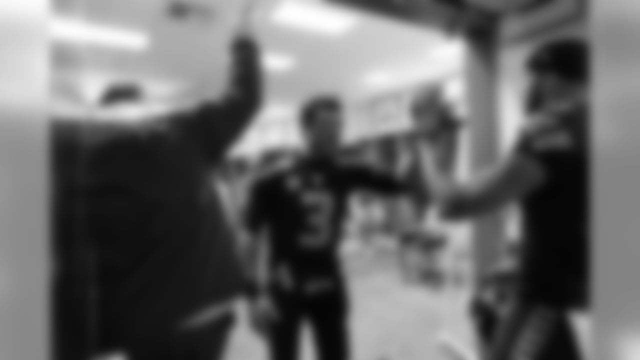 Quarterback Russell Wilson greets teammates as they return to the locker room at halftime.