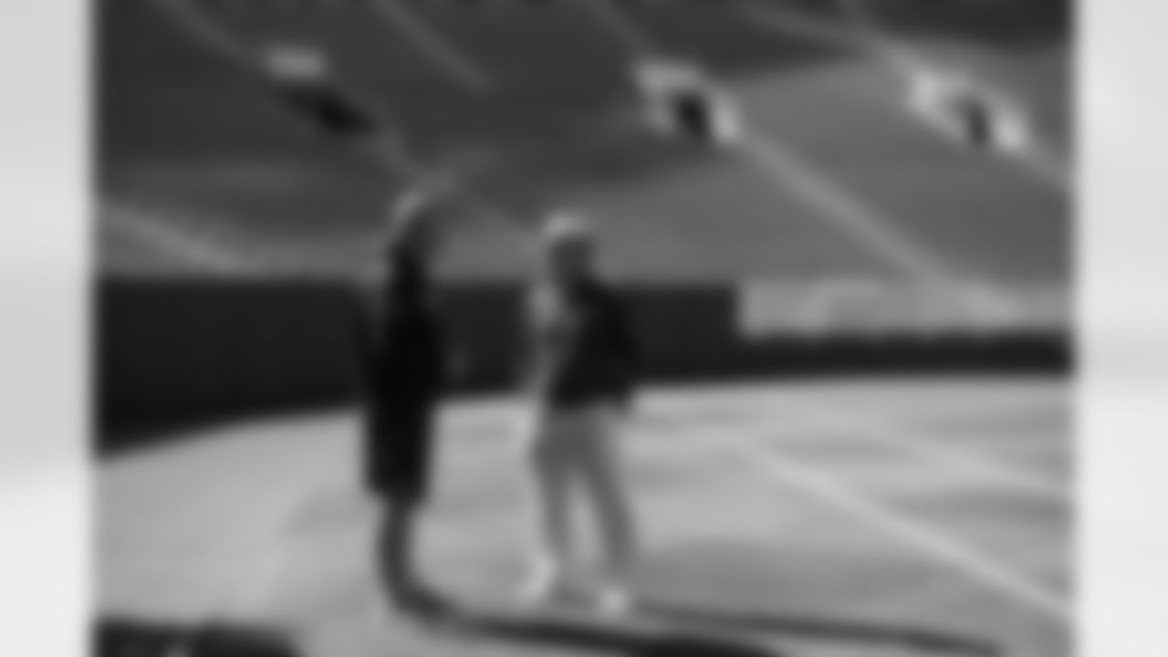 Offensive line coach Tom Cable and head coach Pete Carroll chat in an empty Lambeau Field on Saturday afternoon.