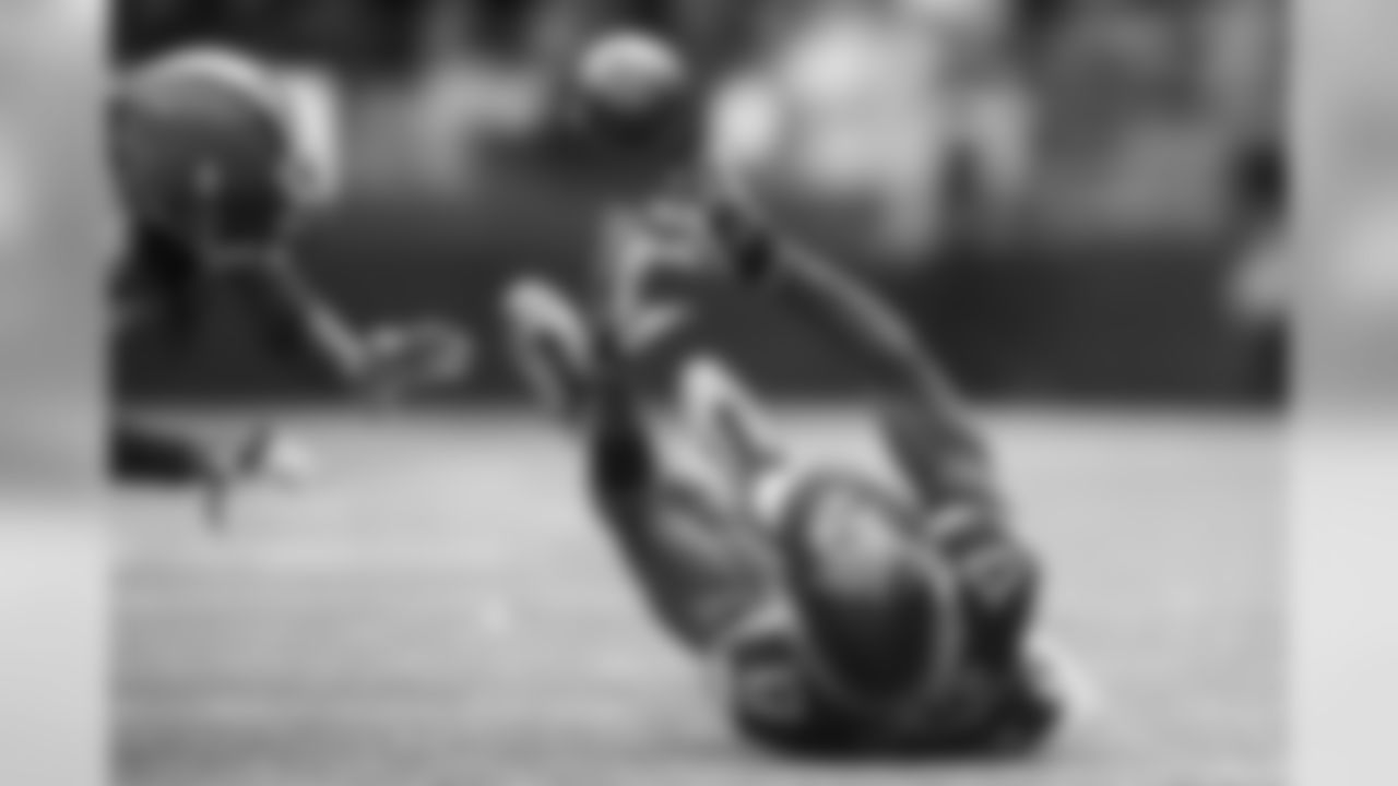Seahawks receiver Kevin Smith tries to make a falling, juggling catch after taking contact from a Cleveland defender while the ball was in the air.
