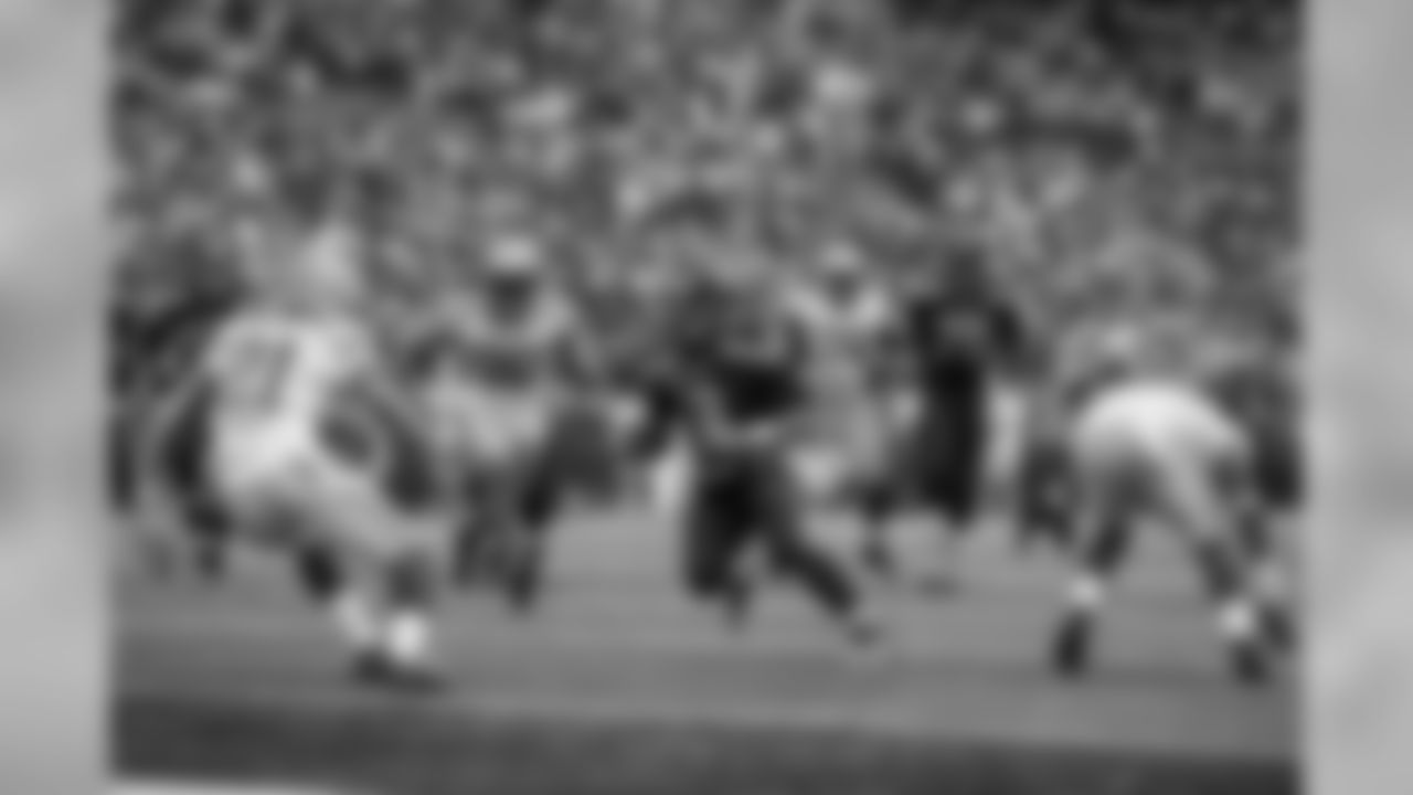 Seahawks quarterback Russell Wilson looks for the end zone late in regulation, and his touchdown and the ensuing extra point left Seattle trailing 19-14 with 2:09 remaining.
