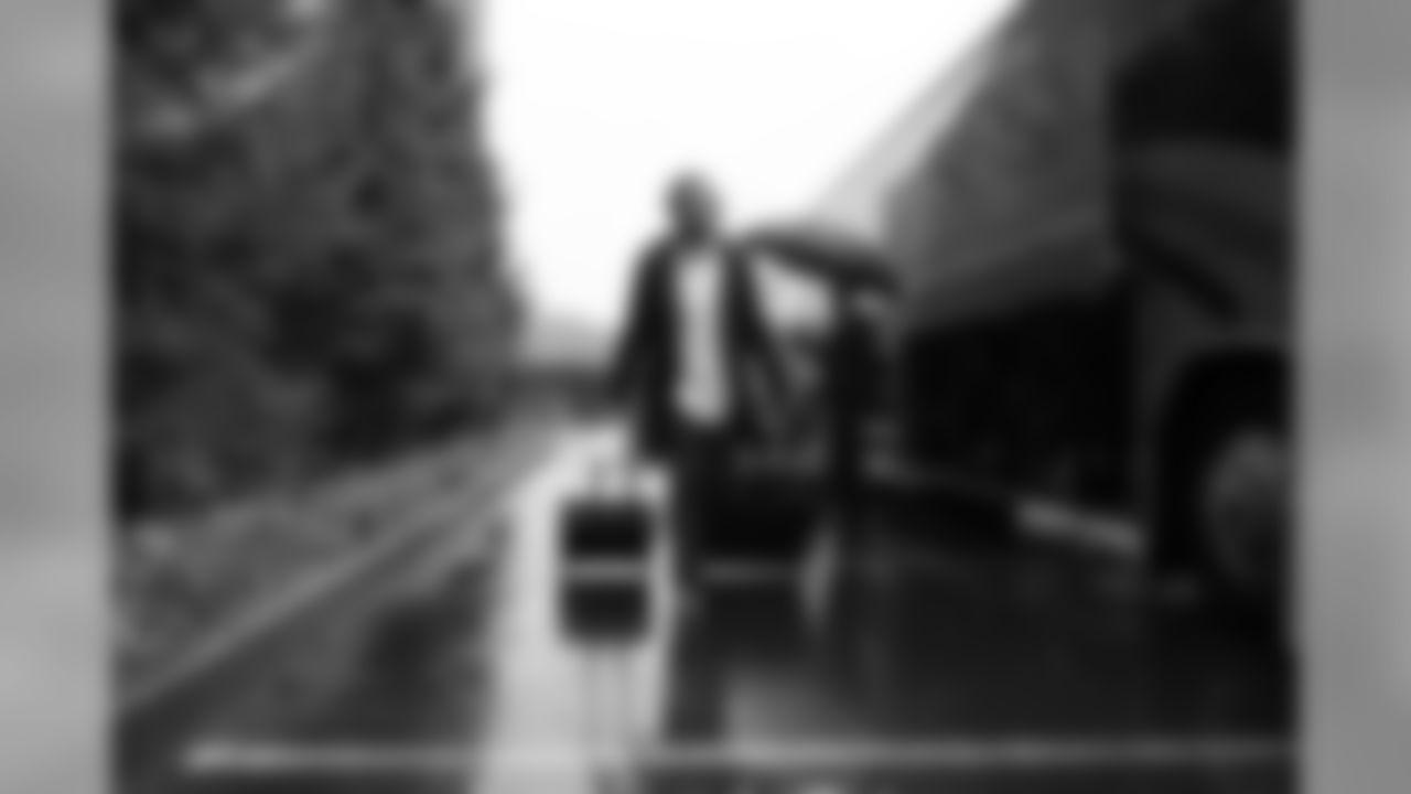 The Seahawks' trip to Arizona began on a rainy day in Seattle. Earl Thomas, sporting new shoes he received as a gift from teammate Kam Chancellor, makes his way to the bus for the ride to the airport.