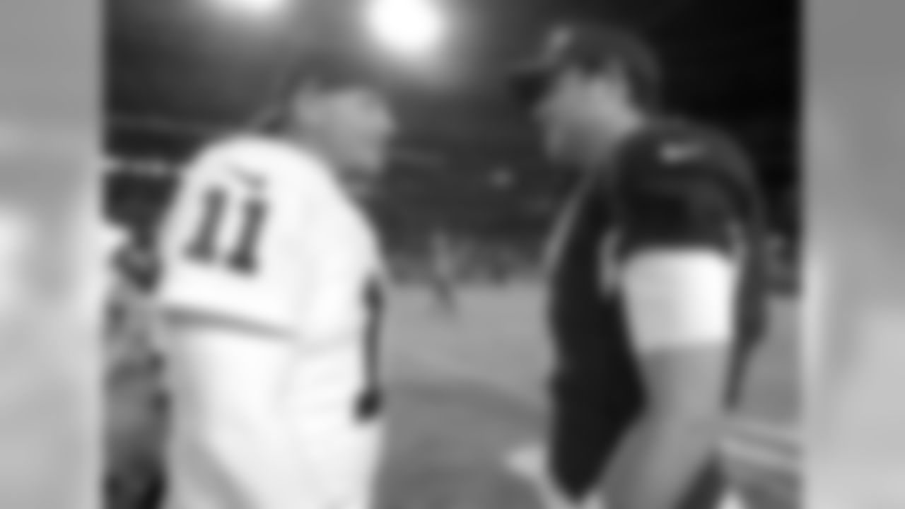 Oakland Raiders kicker Sebastian Janikowski (11) and Arizona Cardinals quarterback Carson Palmer (3) after an NFL preseason football game, Friday, Aug. 12, 2016, in Glendale, Ariz. (AP Photo/Rick Scuteri)