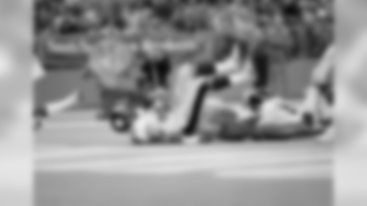 Franco Harris (32) of the Pittsburgh Steelers slides into the end zone for six points after being hits by Kenny Easley (45) and Kerry Justin of the Seattle Seahawks in the first quarter of their game in Seattle, Wash., Oct. 23, 1983. Harris went nine yards for the score. (AP Photo/Barry Sweet)