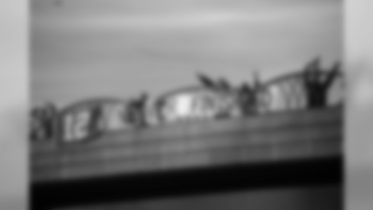 Fans not only lined the sidewalks and streets along the route to the airport, they also lined freeway overpasses to send good wishes to the team.