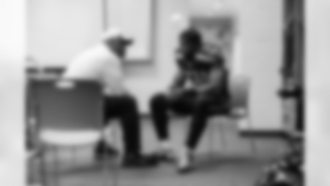 Linebackers coach Ken Norton, Jr., confers with middle linebacker Bobby Wagner.