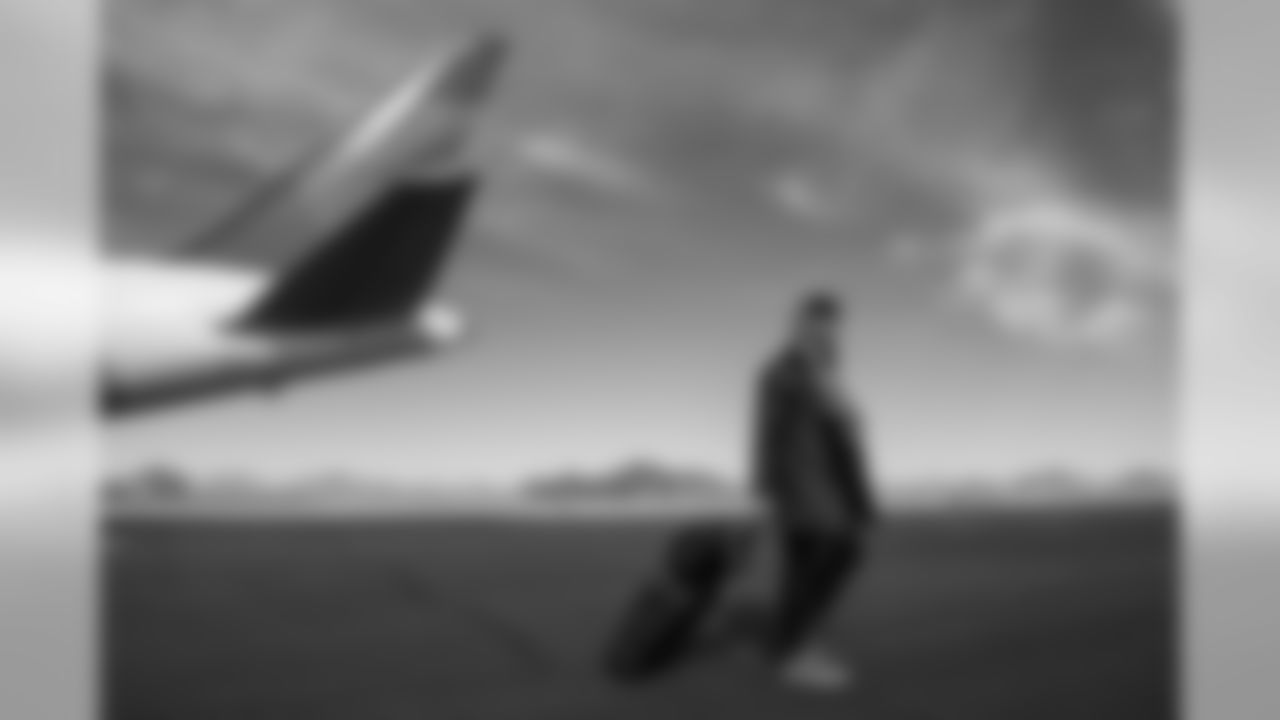 Russell Wilson walks from the charter to the bus as sunny skies greeted the Seahawks upon landing in Phoenix.