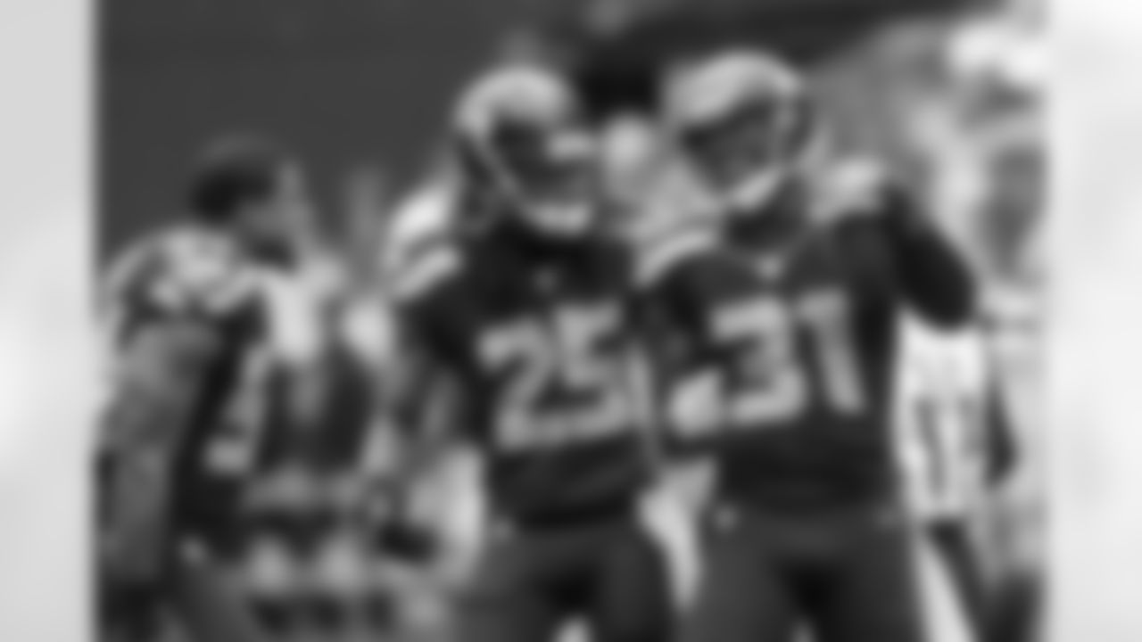 Bobby Wagner and Richard Sherman celebrate with Kam Chancellor after his interception.