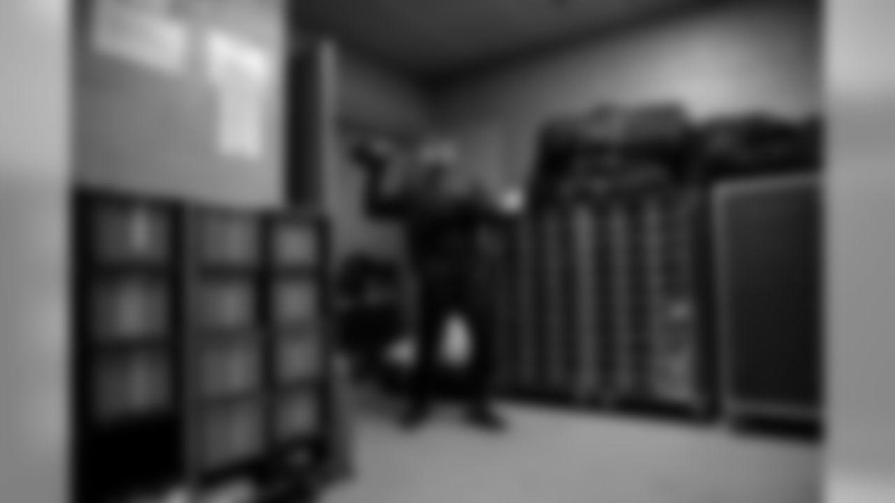 Quarterback Russell Wilson tosses the football in a back corner of the locker room at FedEx Field when the team took a brief visit to the stadium after the Sunday walk-thru.