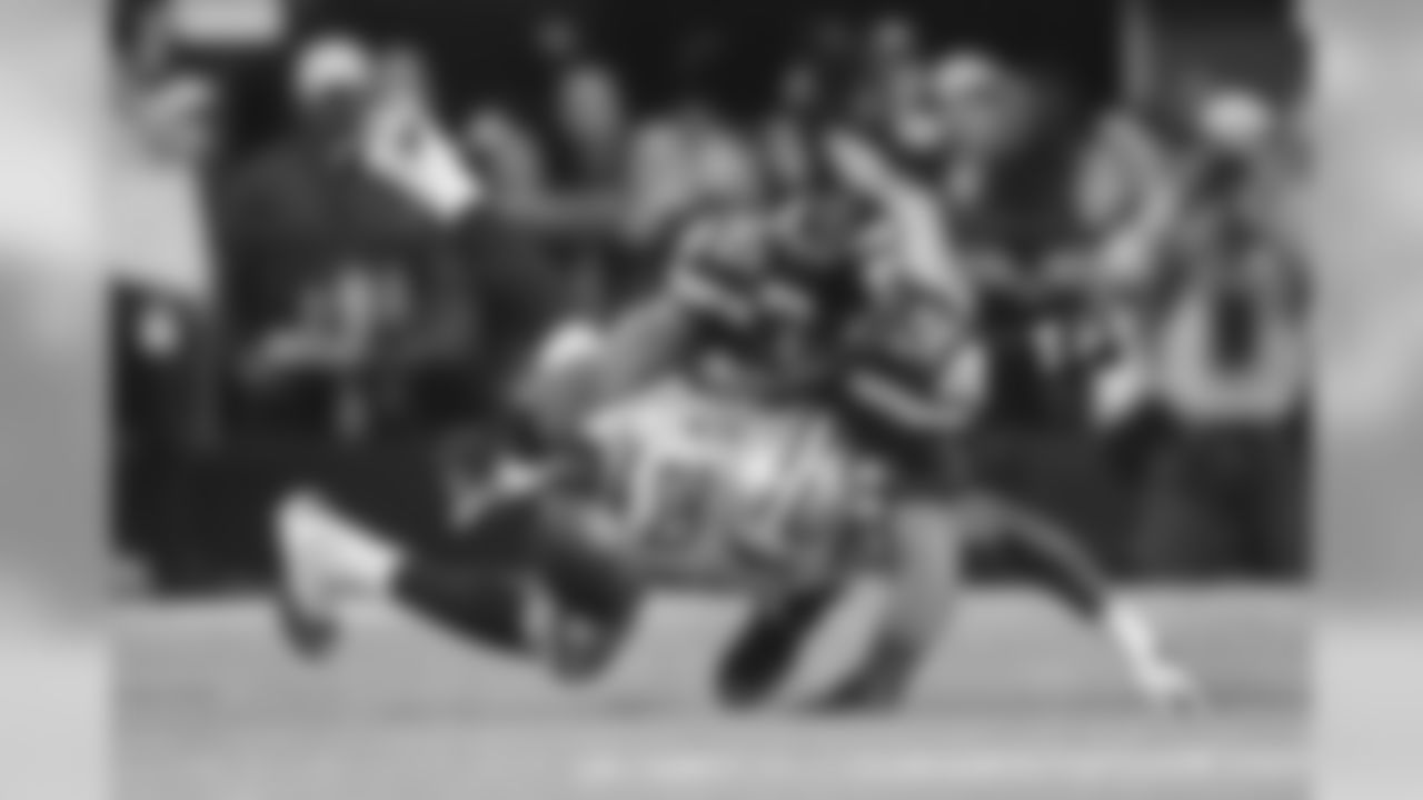 K.J. Wright leaps over a fallen Darren McFadden after the Dallas running back lost the football on a pass reception. Seattle recovered but the play was overturned upon review.