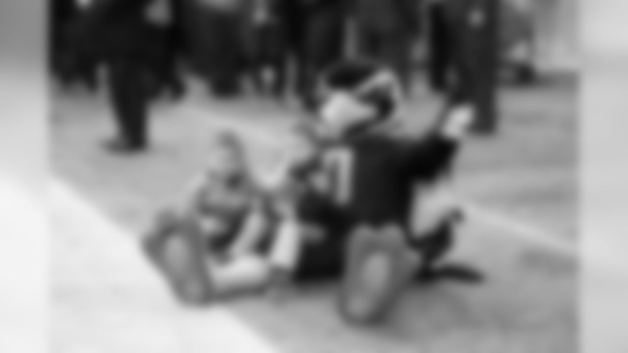 Blitz snags a couple of young fans to watch the pregame show before kickoff.
