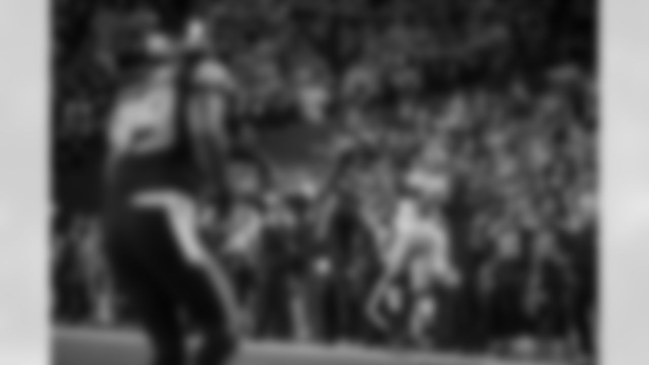 Seahawks cornerback Richard Sherman skies to intercept a deep pass intented for San Francisco's Vernon Davis along the Seattle sideline as head coach Pete Carroll (lower right) watches.