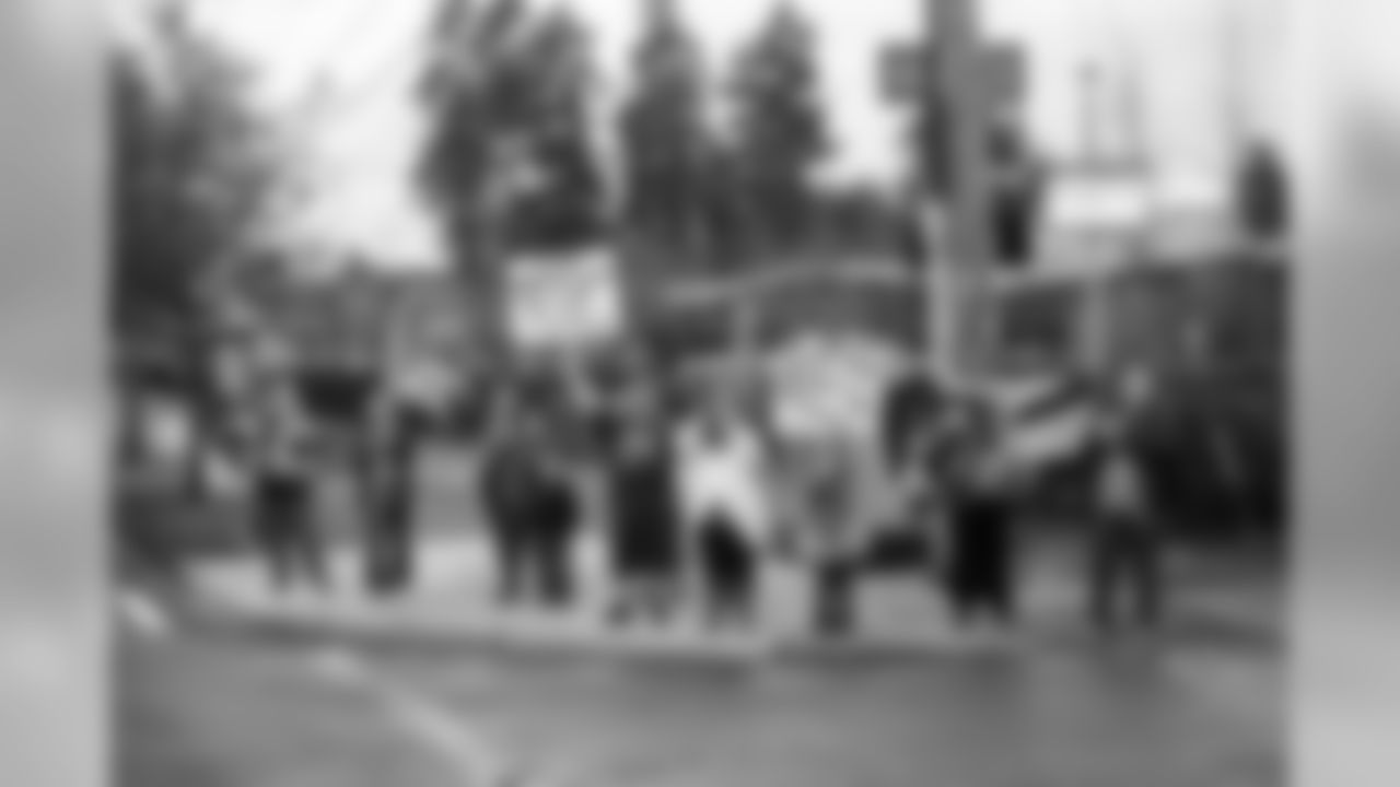 Fans waited on a corner in Sea-Tac to send the team off with cheers, waves, signs and flags.