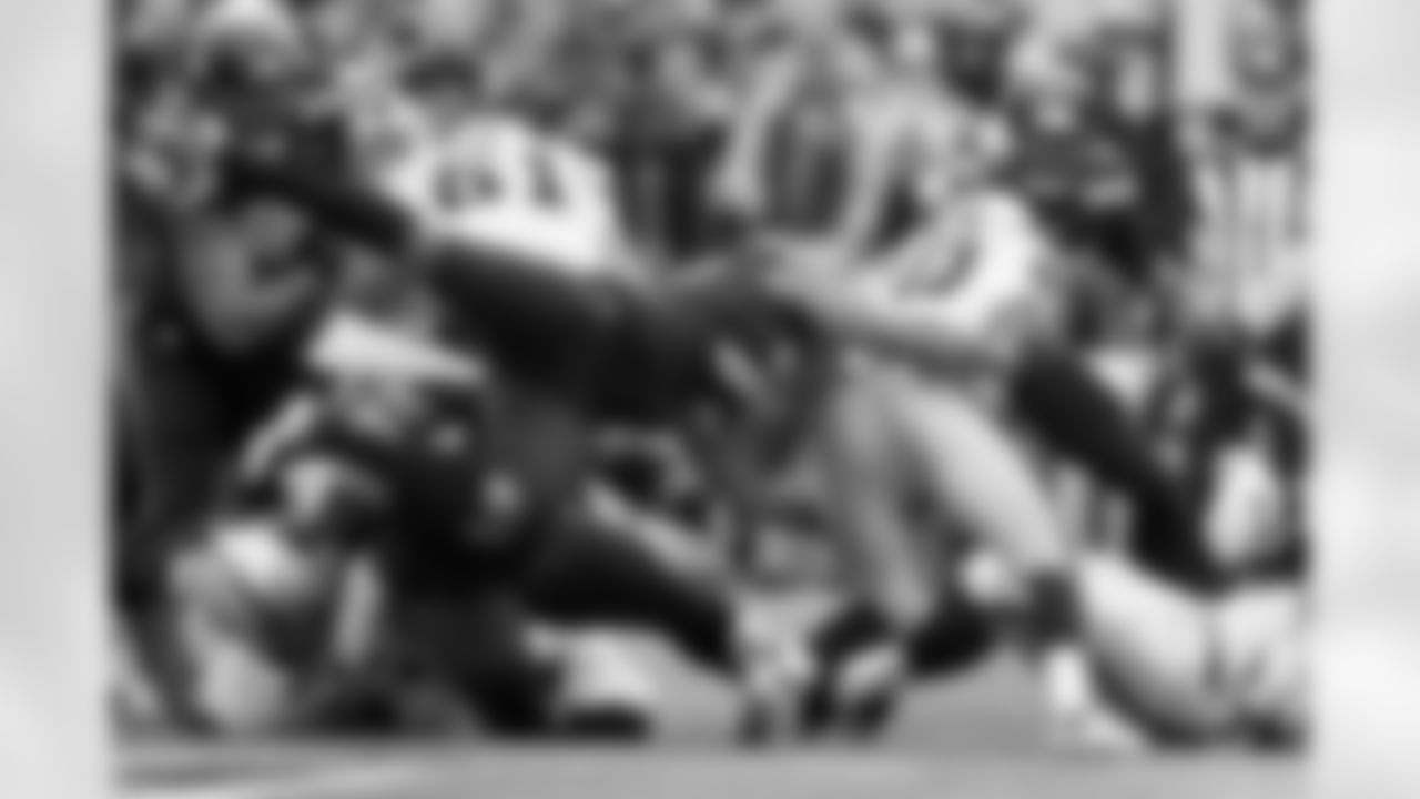 Michael Bennett goes flying through the air to stop Oakland's Darren McFadden in the second quarter.