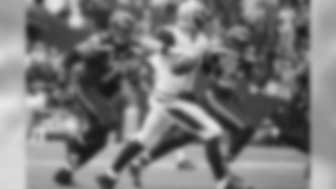 The defensive eyes of Red Bryant and Cliff Avril are on Jacksonville's Chad Henne as he escaped the pocket looking for a receiver.