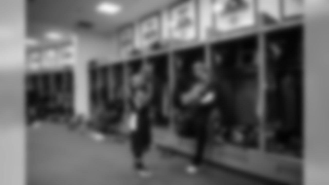 Receiver Doug Baldwin goes over play calls and formations with assistant wide receivers coach Nate Carroll in the Seahawks locker room.