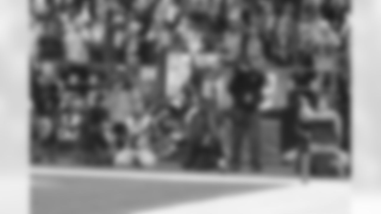 Deion Branch holds the ball high for the crowd after a TD reception.