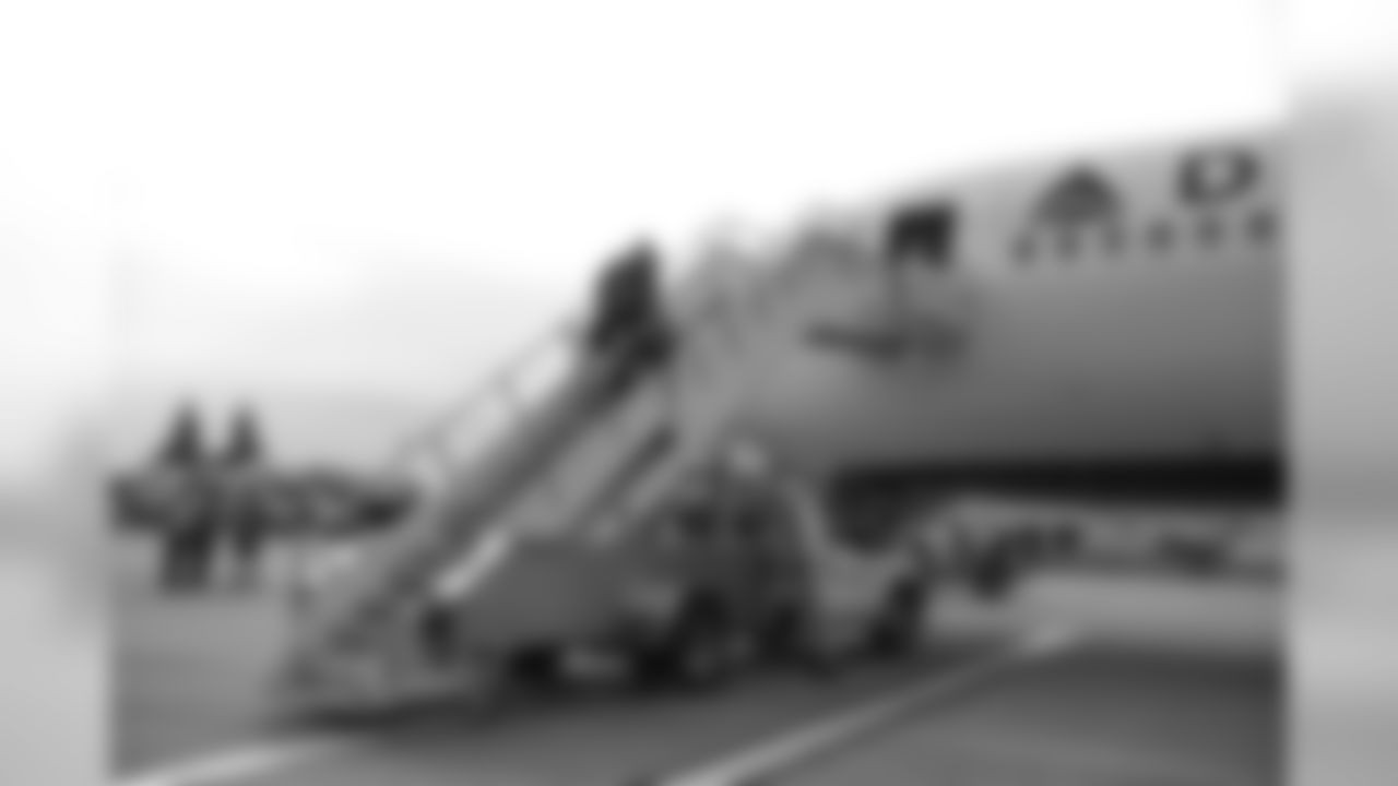 Head coach Pete Carroll boards the team's charter at SeaTac Airport for the road trip.