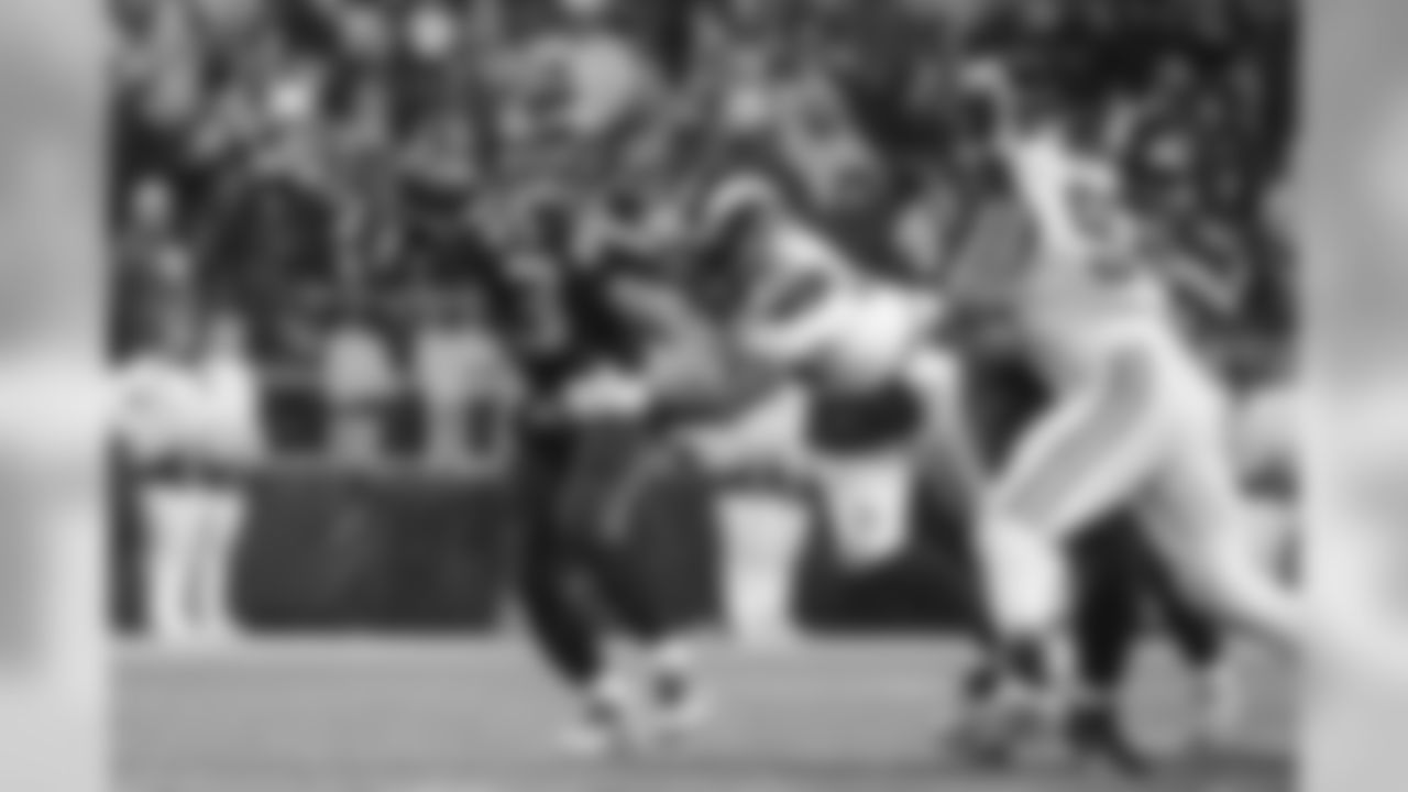 Under pressure from St. Louis defender William Hayes, Seahawks quarterback Russell Wilson dumps a short pass off to running back Fred Jackson.