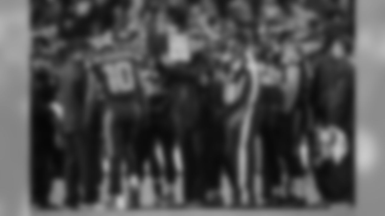 With the Seahawks nursing a six-point lead late in the game, special teams coach Brian Schneider reviews the team's onside kick recovery strategies during a timeout.
