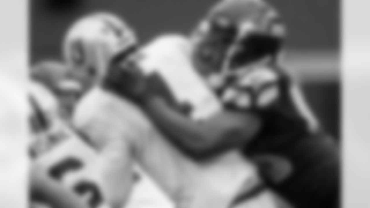 Linebacker Cliff Avril crushes Oakland quarterback Derek Carr near the end of the second quarter.