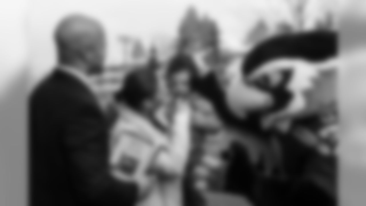 SUNDAY - JAN 25 -- As defensive backs coach Kris Richard, left, prepares to board the team buses to the airport, his wife Chandra and Seahawks mascot Blitz comfort the Richard's tearful youngest son, Asher.