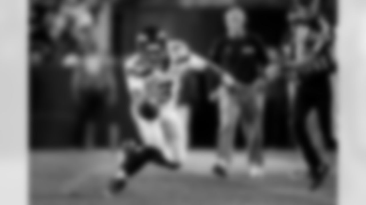 Quarterback Russell Wilson did his damage with both his arm and his legs as he reaches the ball towards the first down marker after escaping the pocket to his left.