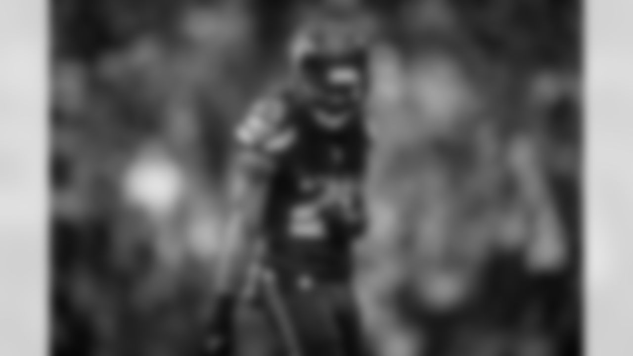 Richard Sherman, holding his elbow close to his body because of the pain of what would later be diagnosed as an elbow sprain, glares towards the Packers huddle between plays.