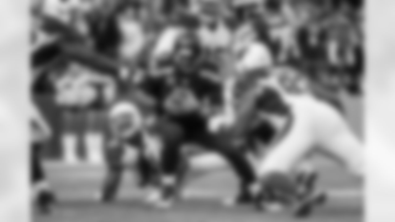 Seahawks quarterback Russell Wilson tries to escape a swarm of Arizona defenders, but is tackled for a loss by the Cardinals' Calais Campbell. Wilson was sacked seven times by the Cardinals defense.