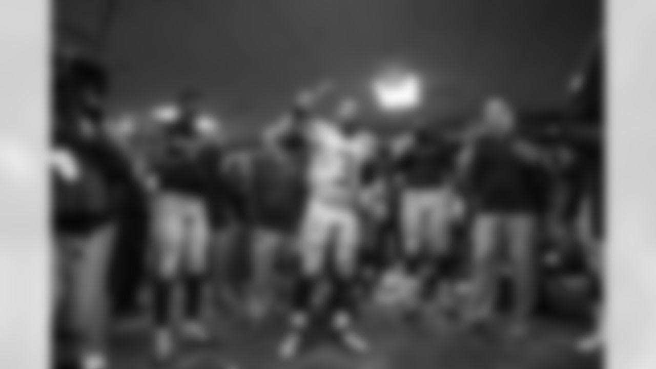 Russell Wilson makes a point with his turkey leg as the team gathers in the locker room after the 19-3 win over division rivals San Francisco.