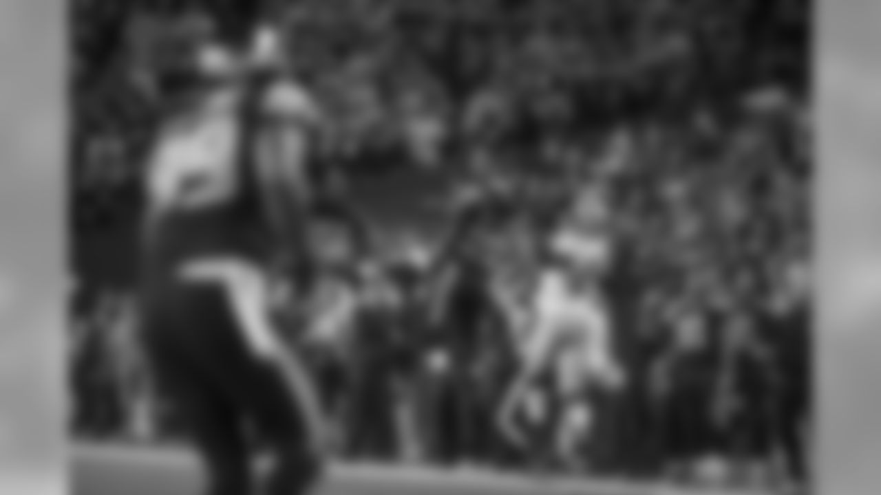 Seahawks cornerback Richard Sherman skies to intercept a deep pass intented for San Francisco's Vernon Davis along the Seattle sideline as head coach Pete Carroll (lower right) watches.