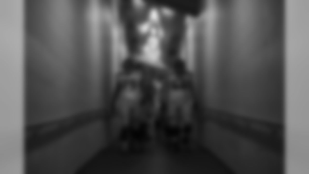 Offensive linemen Garry Gilliam and Justin Britt lead the way down the narrow tunnel from the locker room to the field in Minneapolis prior to the game with the Vikings.