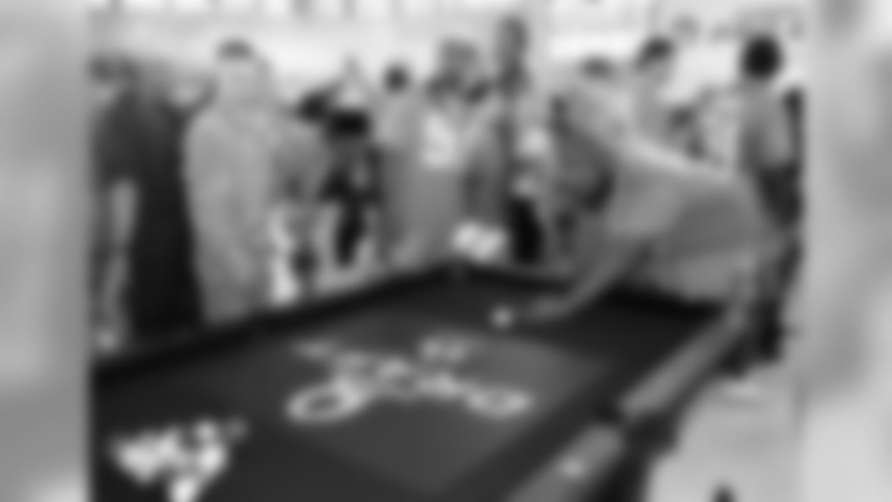 IMAGE DISTRIBUTED FOR USAA - NFL Pro Bowlers Everson Griffen, center, and Michael Bennett, right, join service members for a game of billiards during the 2016 NFL Pro Bowl Draft presented by USAA at Wheeler Army Airfield, on Wednesday, Jan. 27, 2016, in Wahiawa, Hawaii. USAA is the Official Military Appreciation Sponsor of the NFL. (Kevin Terrell/AP Images for USAA)