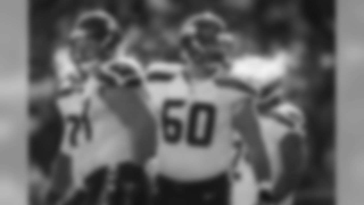 Breath from offensive linemen J.R. Sweezy, left, and Max Unger is visible as temperature at game time in Kansas City was below freezing.