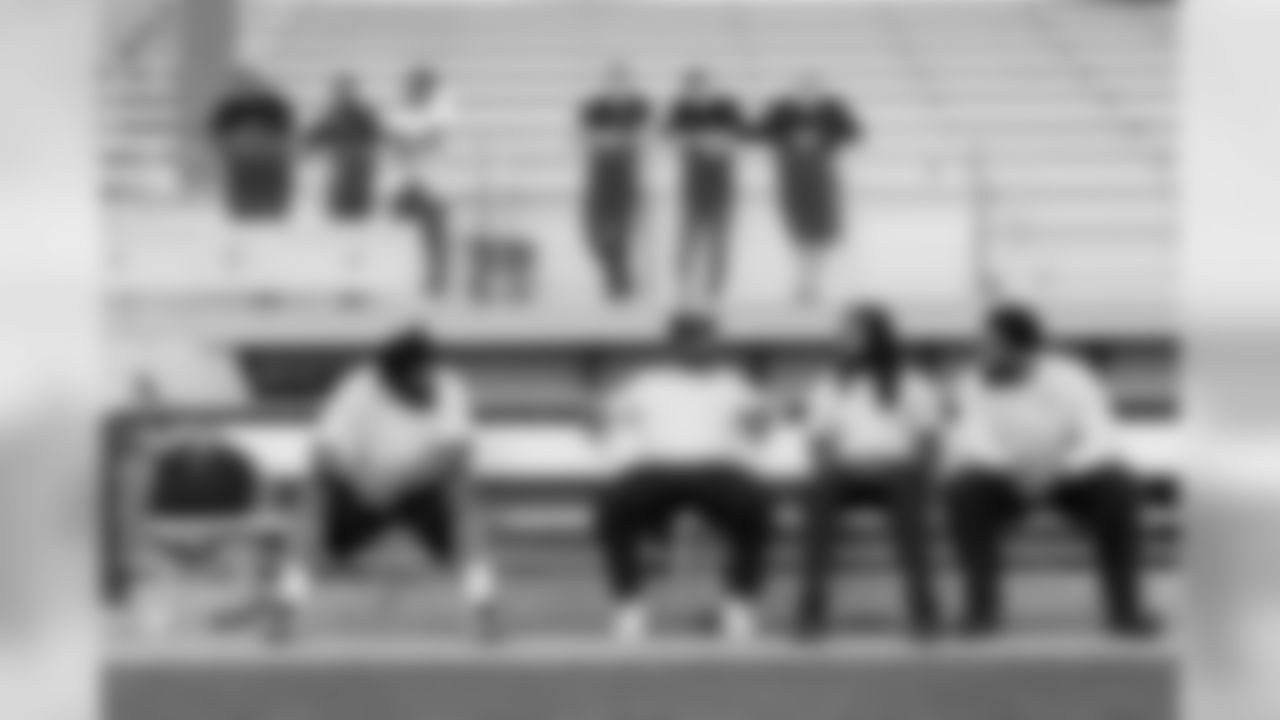 While the offense runs through plays, members of the defense including Sheldon Richardson, Cliff Avril, Richard Sherman and Michael Bennett sit on a nearby bench waiting their for their turn.